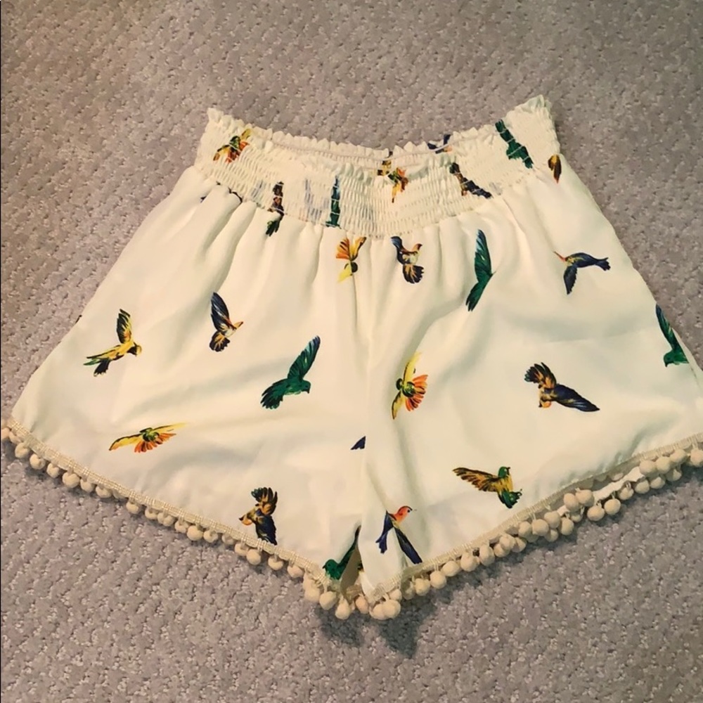 Cream shorts with bird graphics